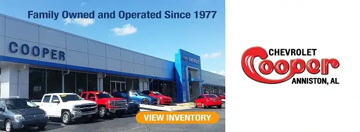 Exterior view of Cooper Chevrolet dealership with text 'Family Owned and Operated Since 1977' and 'View Inventory'. Cooper logo. 